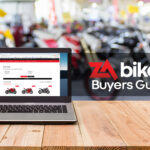 Computer,On,The,Table,,Blur,Image,Of,Motorcycle,Showroom,As