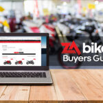 Computer,On,The,Table,,Blur,Image,Of,Motorcycle,Showroom,As